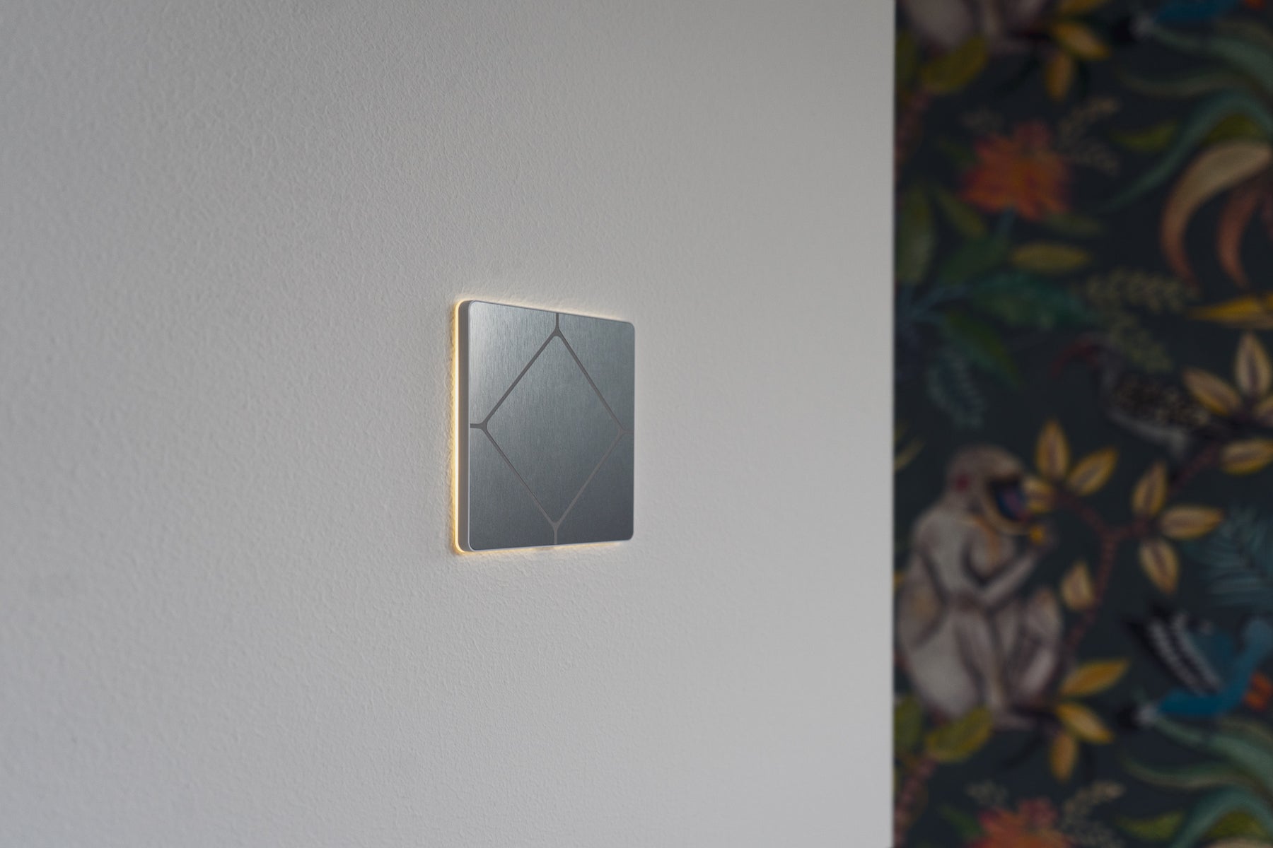 Faradite TAP Volt Free switch in Brushed Stainless Steel finish with the halo light on. 