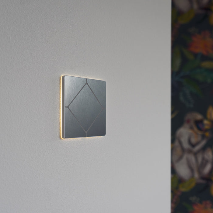 Faradite TAP Volt Free switch in Brushed Stainless Steel finish with the halo light on. 